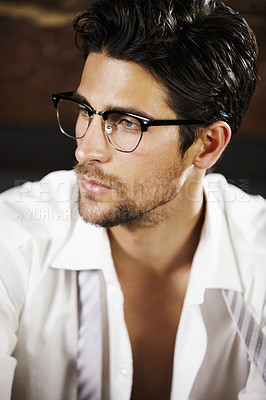 Buy stock photo Sexy young man looking away while wearing glasses and a slightly parted shirt