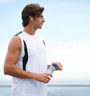 Buy stock photo Thinking, fitness and a man with water and music after running, exercise or outdoor cardio. Break, relax and a runner with a drink while listening to a podcast after training or sports in nature