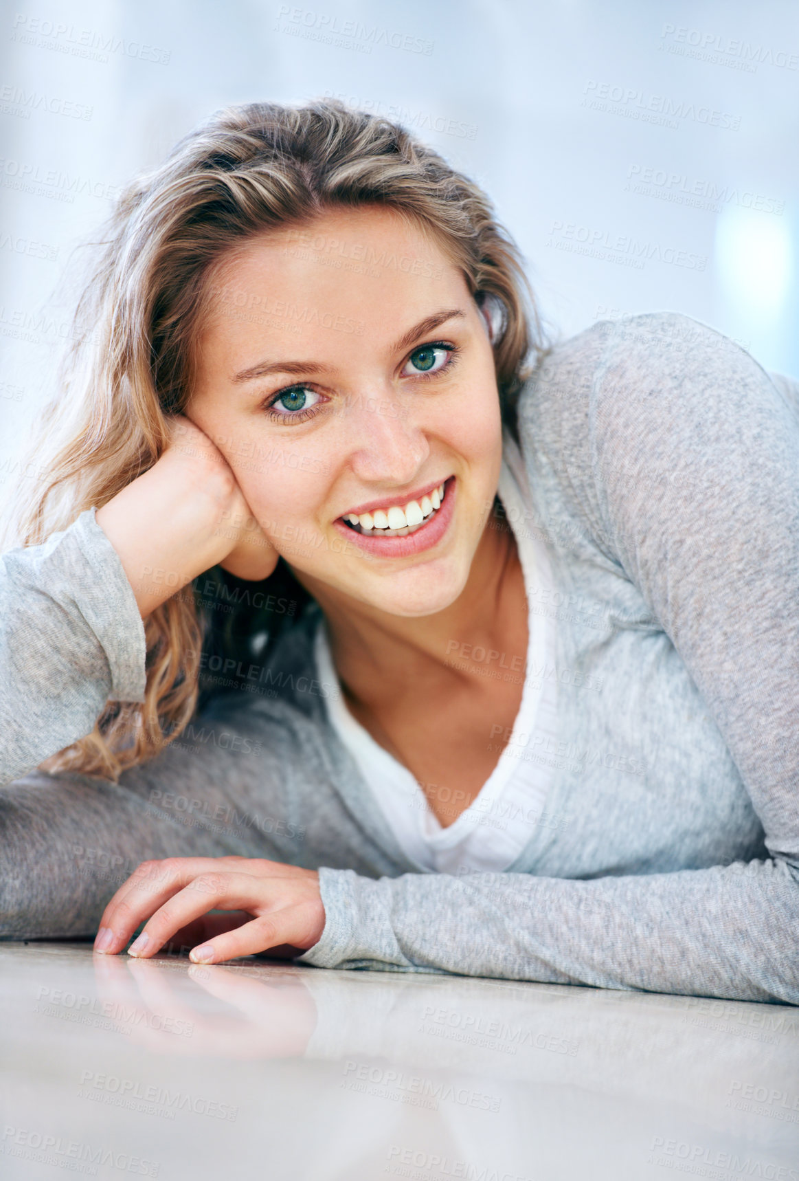 Buy stock photo Woman, portrait and floor lying smile in home for cheerful friendly, calm or feminine look. Female person, happy face and hand on ground for attractive, lazy weekend joy or positive relax in Canada