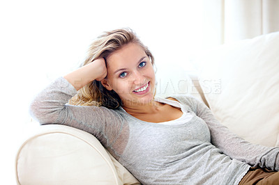 Buy stock photo Portrait of a young woman relaxing on her couch at home
