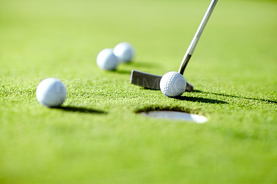 Buy stock photo Closeup, golf and ball with club for shot in hole for practice, exercise or wellness to relax on grass. Sports, course or target for challenge on field in summer for competition, recreation or hobby