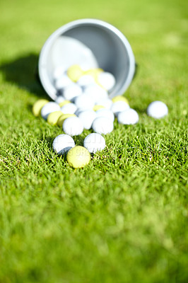 Buy stock photo Shot of a bucket of golf balls on a golf course
