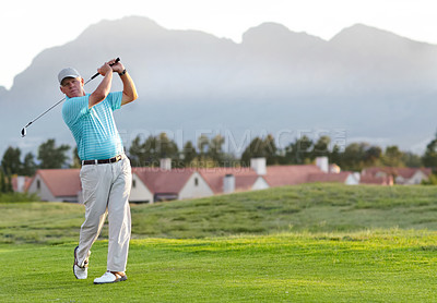 Buy stock photo A male golfer admiring the shot he has just played