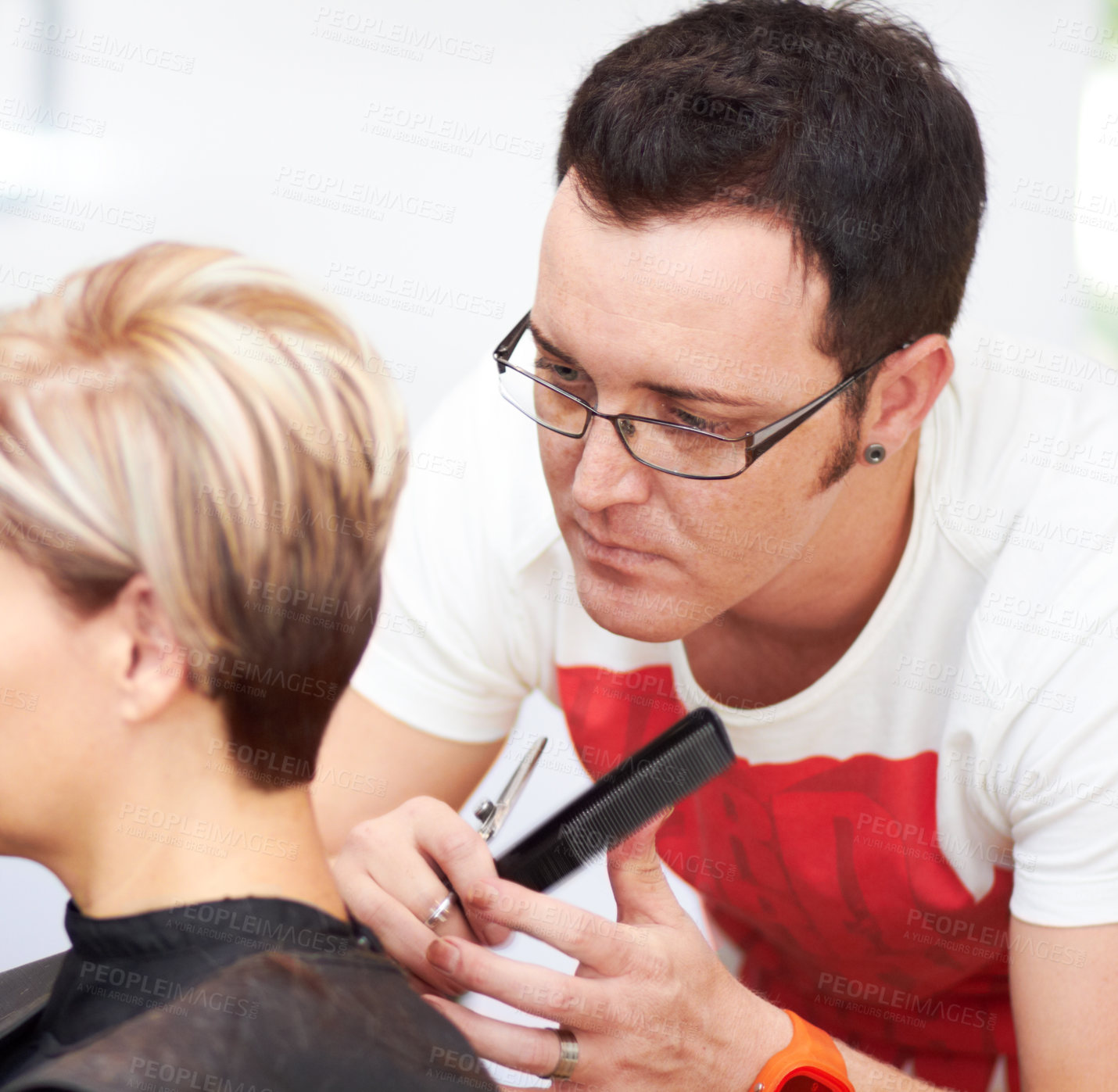 Buy stock photo A hairdresser putting the final touches on his client&#039;s head