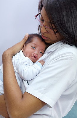 Buy stock photo Medicine, cleft lip and a pediatrician with a baby in the hospital for healthcare, insurance or treatment. Medical, children and a doctor woman holding a newborn infant with a disability in a clinic