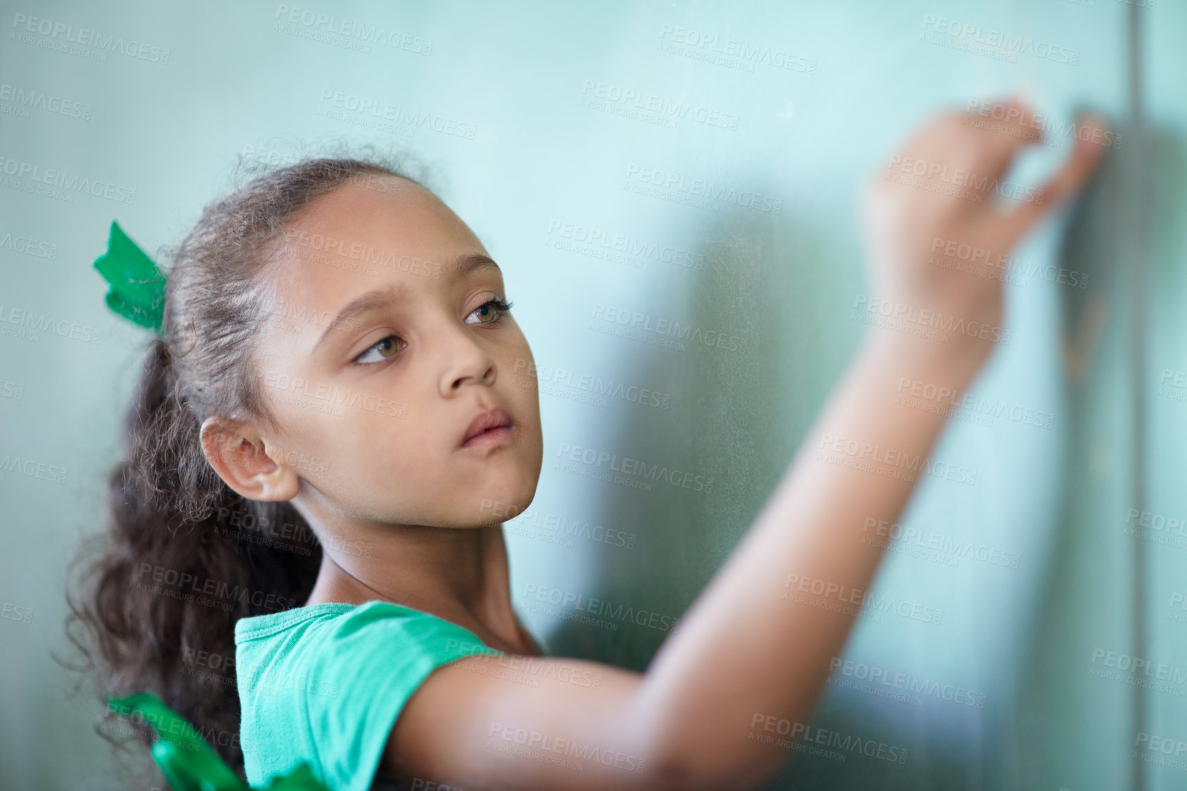 Buy stock photo Education, focus and a girl writing on a chalkboard for learning, studying and teaching in class. Creative, concentration and a young student at a blackboard for a presentation or classroom notes