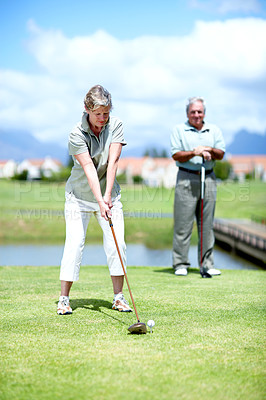 Buy stock photo Mature, woman or golfer playing golf for fitness, workout or stroke exercise on a course in retirement. Senior couple, golfing or serious lady training in sports game to swing with her club or driver