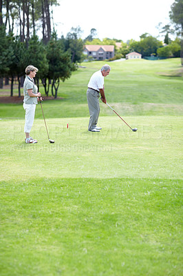 Buy stock photo Old couple, sports or golfer playing golf for fitness, workout or exercise to swing on a course or field. Senior woman, elderly man golfing or training in practice game and driving with a club stroke