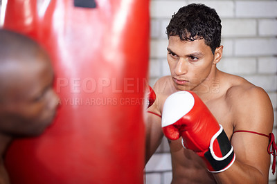 Buy stock photo Personal trainer, fitness and a man with a punching bag for boxing, exercise and cardio at a gym. Workout, wellness and a boxer or athlete with a person for training or getting ready for a match
