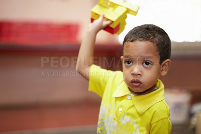 Buy stock photo Boy, education and building blocks in classroom for development, scholarship and thinking at kindergarten. Happy student child, plastic toys and playing with idea for learning, academy or preschool