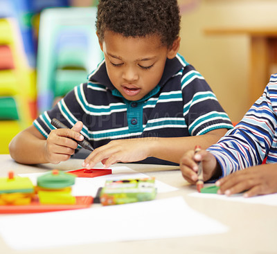 Buy stock photo African boy, learning and writing at kindergarten with paper, crayon and thinking of sketch for art in classroom. Preschool kids, drawing and color at desk for development, scholarship and education