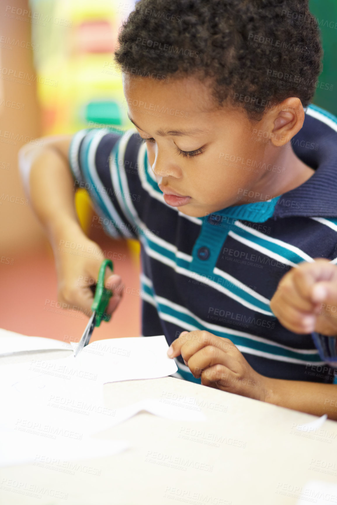 Buy stock photo Boy, classroom and scissor for cutting paper with learning, thinking and development in kindergarten. African child, education and ideas at preschool academy for skills, scholarship or knowledge