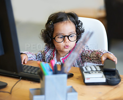 Buy stock photo Shot of an adorable little girl playing businesswoman at a desk
