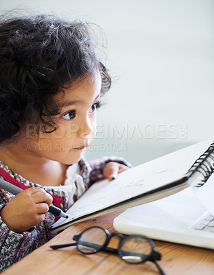 Buy stock photo Drawing, learning and a child with a book for notes, creativity and art at a table. House, study and a girl, kid or baby writing in a notebook for education, learning or a picture on paper at home