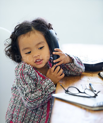 Buy stock photo Playing, talking and a child on a telephone for communication, pretend work and cute. Sitting, house and a girl, kid or a baby speaking on a landline phone for play, imagination or discussion