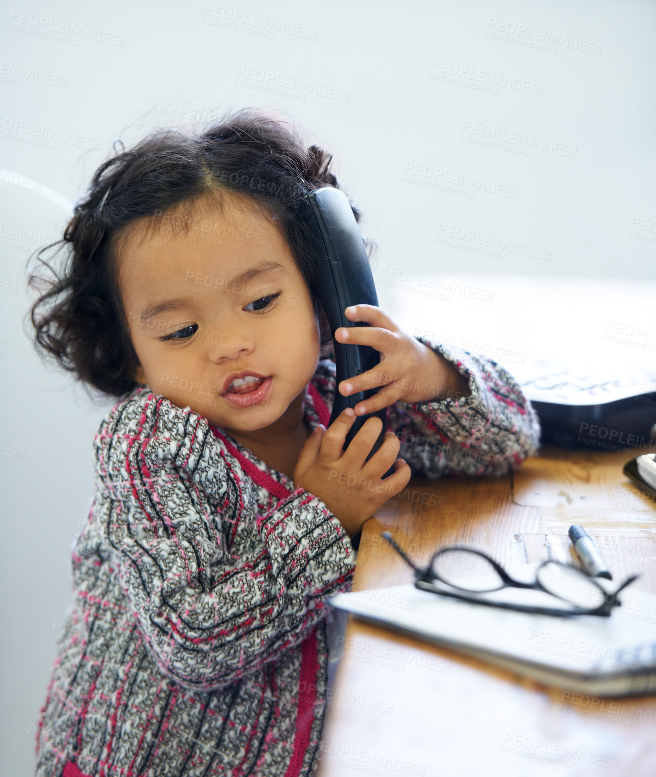 Buy stock photo Playing, talking and a child on a telephone for communication, pretend work and cute. Sitting, house and a girl, kid or a baby speaking on a landline phone for play, imagination or discussion