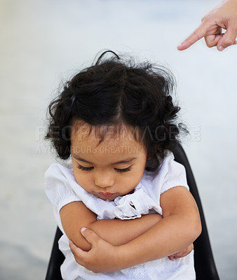 Buy stock photo A little girl being scolded for being naughty