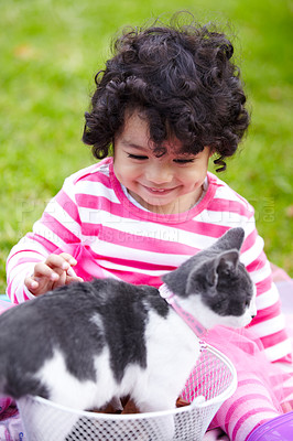 Buy stock photo Cute little girl sitting on the lawn with her cute kitten in a basket