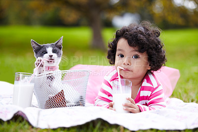 Buy stock photo Portrait, milk and a girl in the park with her kitten together for love, care or bonding during summer. Picnic, cat or kids and a cute young child in the garden having fun with her pet animal