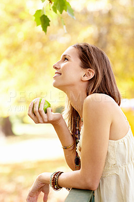Buy stock photo Apple, park and woman with thinking in nature eating fruit for health with smile and happiness on a farm. Wellness, happy and young person on a diet for nutrition and summer of organic agriculture