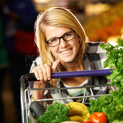 Buy stock photo Portrait of a young woman shopping at the grocery store