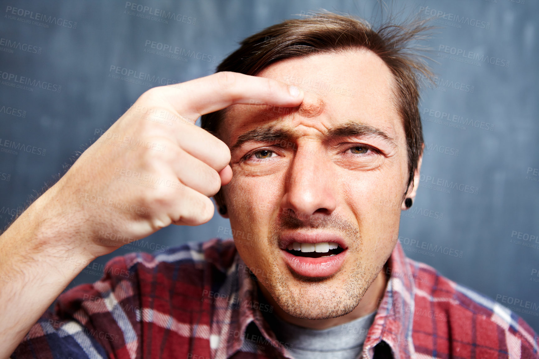 Buy stock photo Portrait of a young man with a giant pimple on his forehead