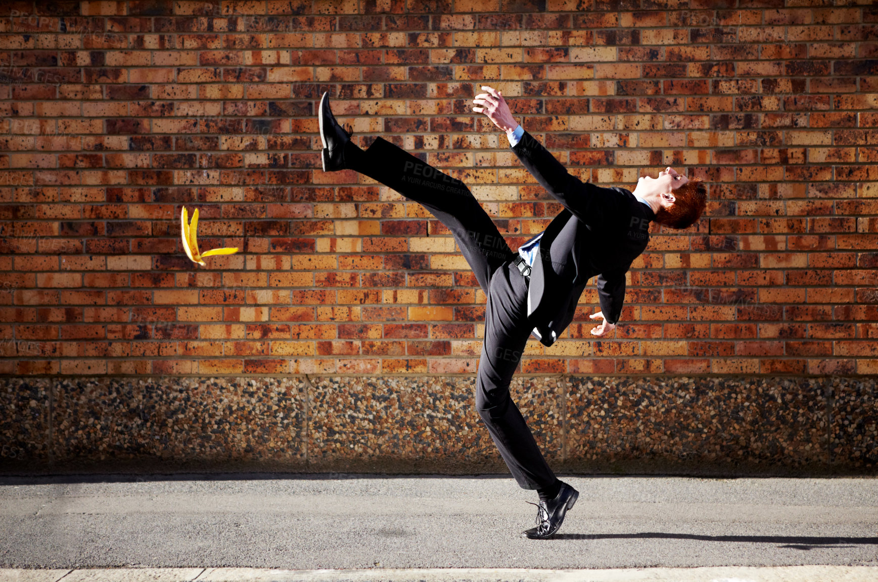 Buy stock photo Accident, slip and banana peel with a business man in the city, falling by mistake on a street.  Walking, step and unlucky with a young professional employee in an urban town for his commute to work