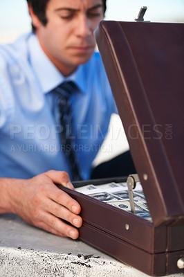 Buy stock photo Businessman, person and briefcase with money with corruption, thief and fraud outdoor for financial crisis. Professional, man and face with contemplation for cash, finance and secret with stress