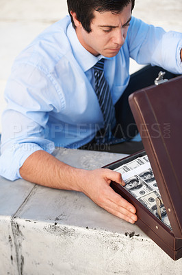 Buy stock photo Businessman, person or briefcase with money or crime and corruption, thief or fraud outdoor for financial crisis. Professional, man or face with contemplation for cash, finance and secret with stress