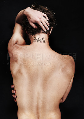 Buy stock photo Back, shame tattoo and nude man in studio isolated on a black background. Rear view, regret and body of person embarrassed at mistake, fail and abuse crisis, depression and mental health challenge