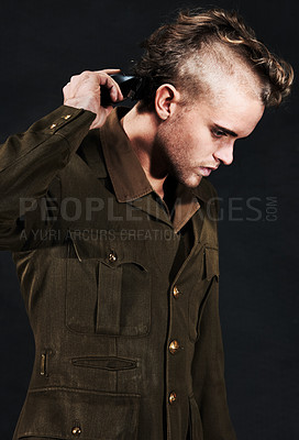 Buy stock photo Military, soldier and man shaving hair in studio isolated on black background. Army, serious and person shave head with clipper machine in profile for haircut to prepare for service, bootcamp or war
