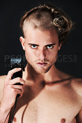 Buy stock photo Portrait of a young man in the process of shaving off his hair