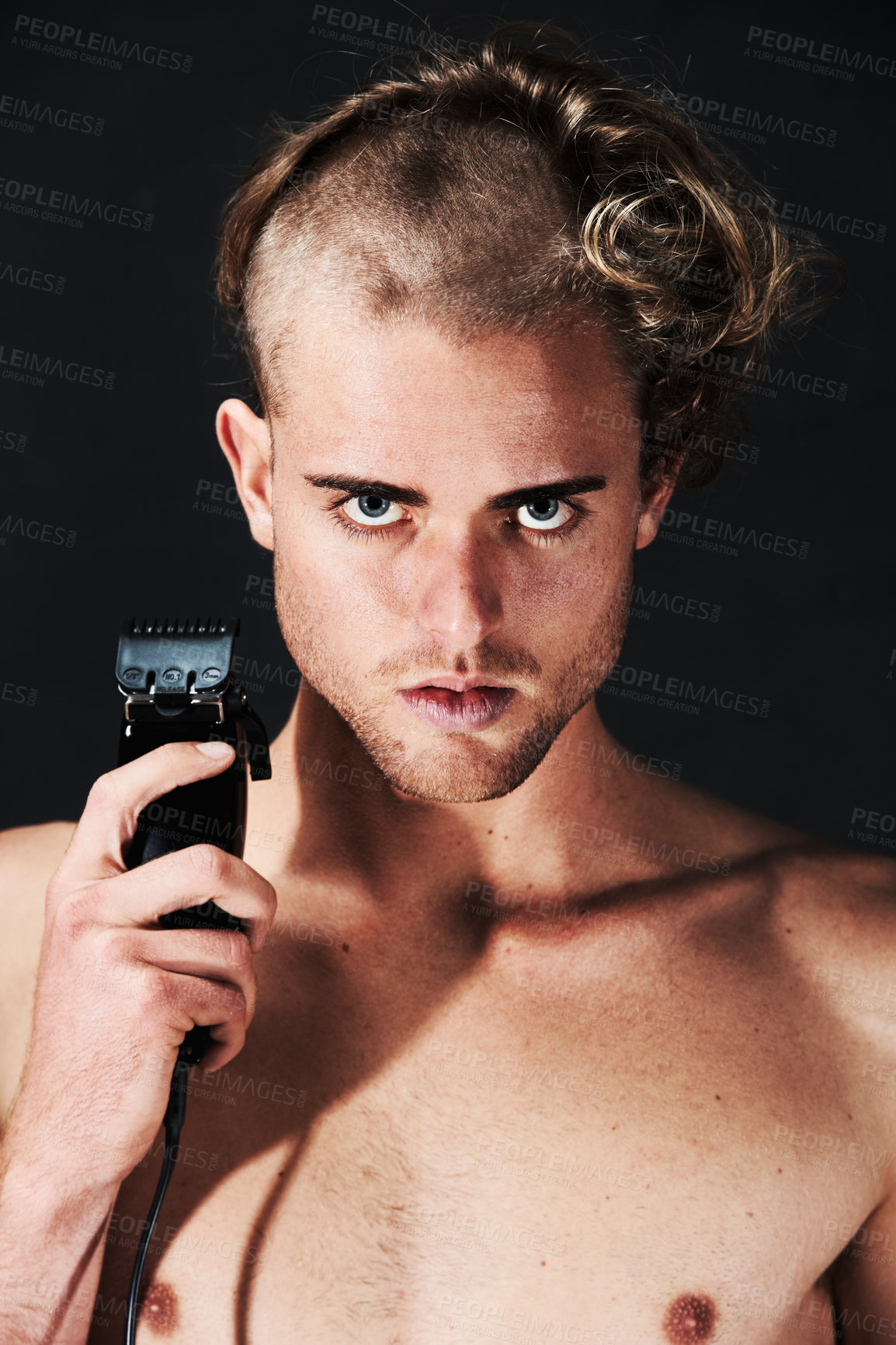 Buy stock photo Portrait of a young man in the process of shaving off his hair