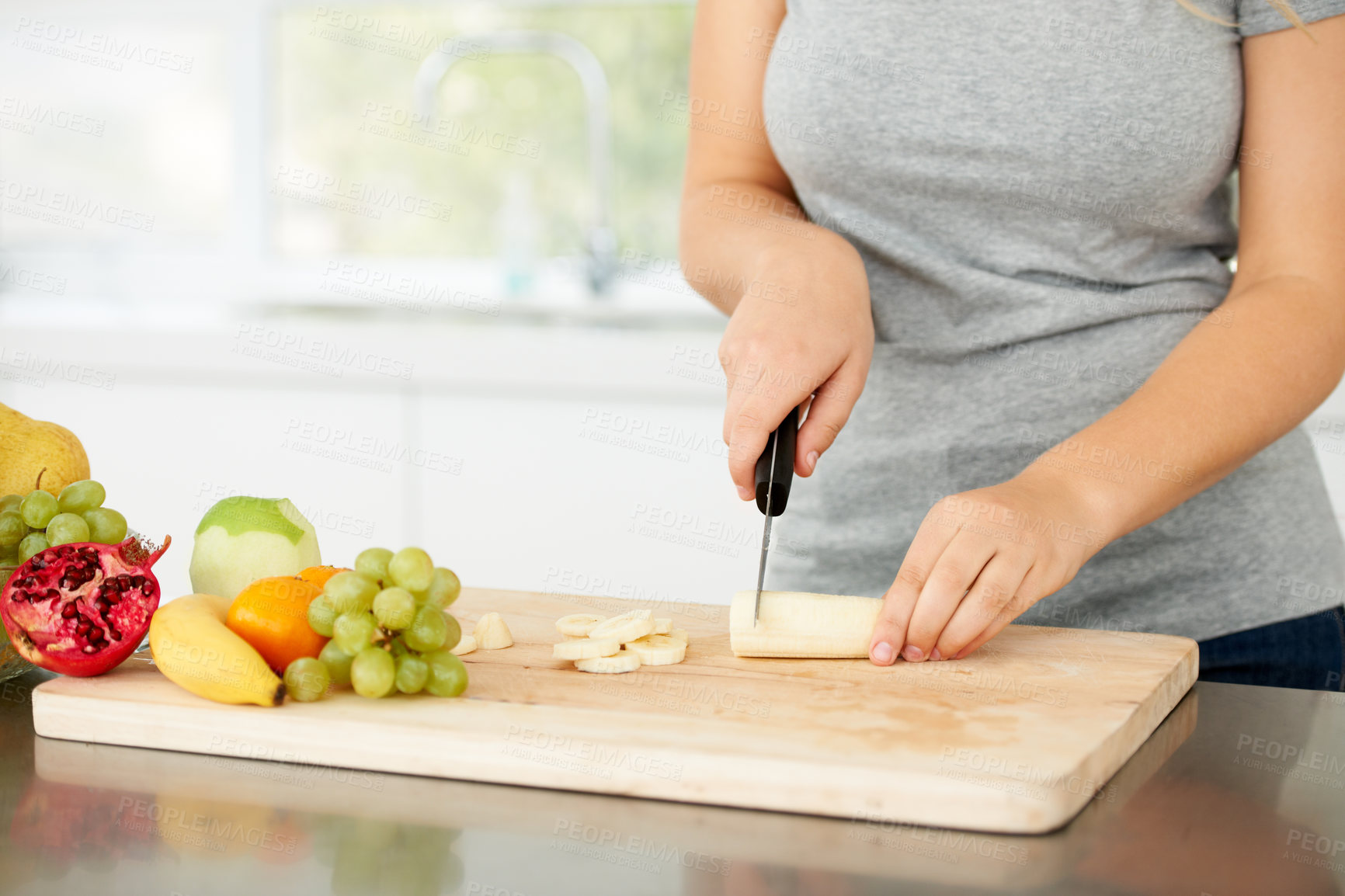 Buy stock photo Woman hands, cooking and fruit for health food and nutrition for weight loss diet and health at home. Kitchen, fruits and chopping banana in a house with breakfast and nutritionist in the morning