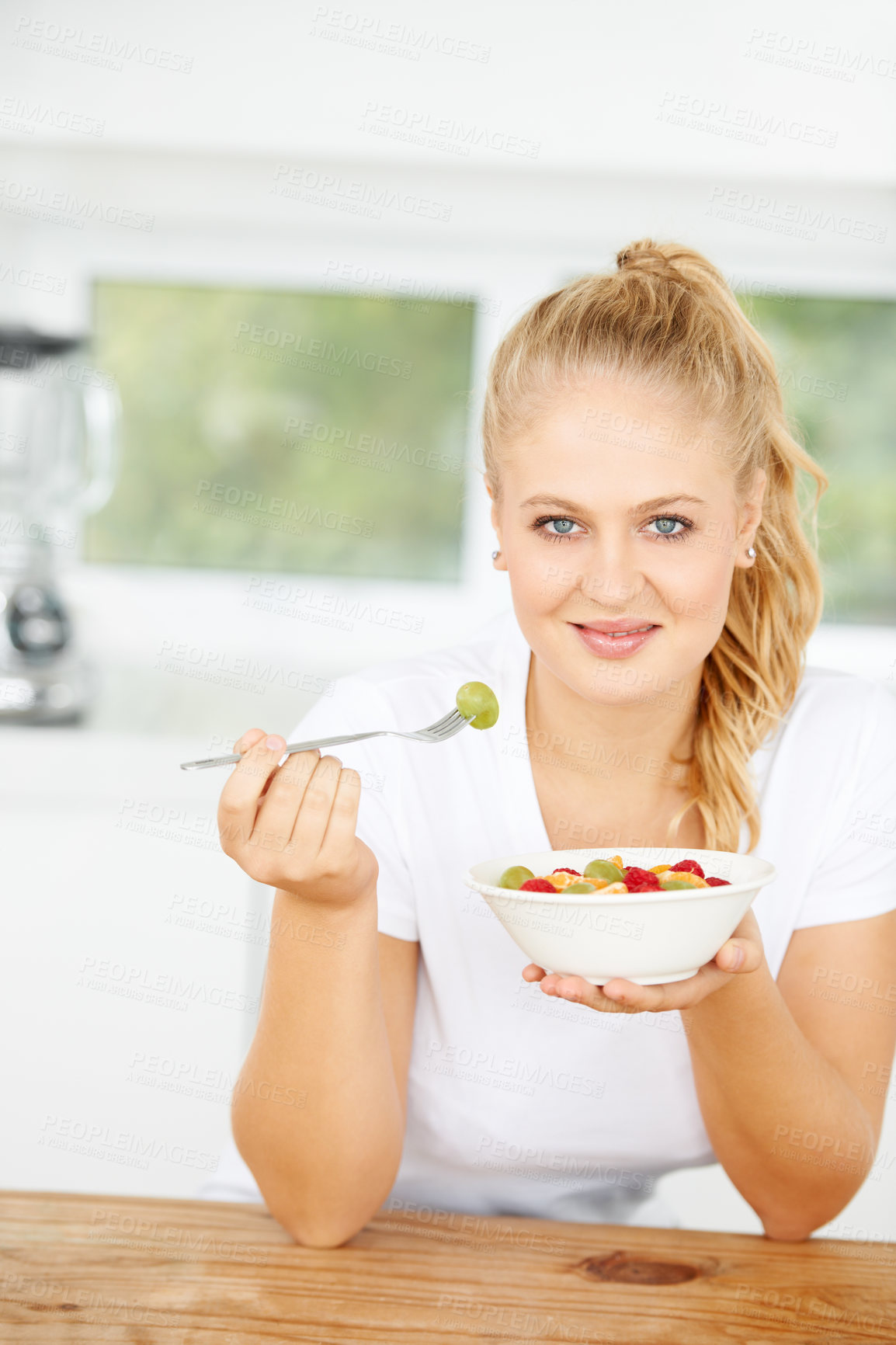 Buy stock photo Fruit salad, eating or portrait of happy woman with a snack, morning breakfast or lunch diet in home kitchen. Face, gut health or girl with fruits, grapes or food bowl meal to lose weight or wellness