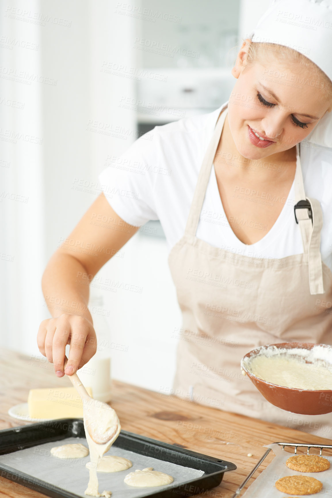 Buy stock photo Happy woman, tray or chef baking cookies with dough or pastry in a bakery kitchen with recipe. Food business, dessert or girl baker smiling or working in preparation of a sweet meal, cake or biscuit