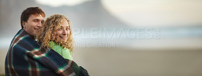 Buy stock photo Beach, sunset and portrait of couple in banner with love, care and support together. People, hug and relax under blanket with happiness on vacation, holiday or travel to the sea for adventure