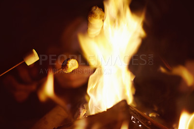 Buy stock photo Outdoor fire, camping and marshmallow in nature, wood and smoke for candy, dessert and night. Dark, person and campfire with people, heating sweats and snack for cooking, campsite and firewood heat