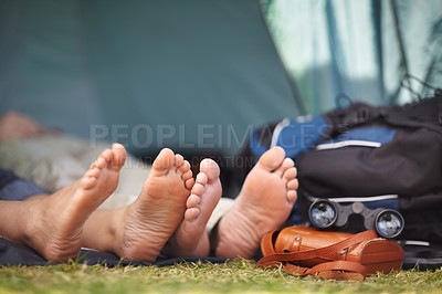 Buy stock photo Sleeping, camping and the feet of a couple on grass closeup for travel, summer or adventure in nature. Binoculars, love or hiking with a man and woman outdoor in the forest together for discovery