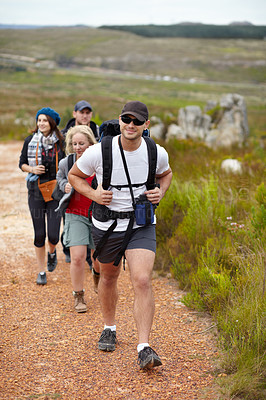 Buy stock photo A happy group of friends walking the hiking trails together