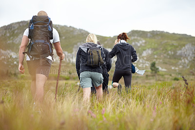 Buy stock photo Nature, backpack and group of friends on hiking adventure in mountain with freedom from back. Travel, trekking and people walking in countryside, men and women on natural outdoor journey together.