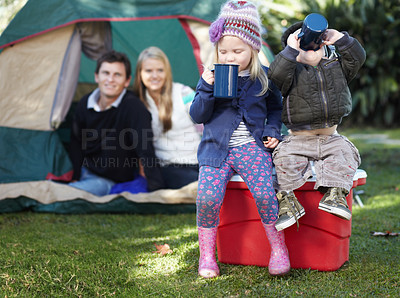 Buy stock photo Morning, coffee and family in nature for camping, relax and children bonding with a drink. Happy, parents and siblings or kids with tea or cacao while at a park for a holiday, vacation or camp