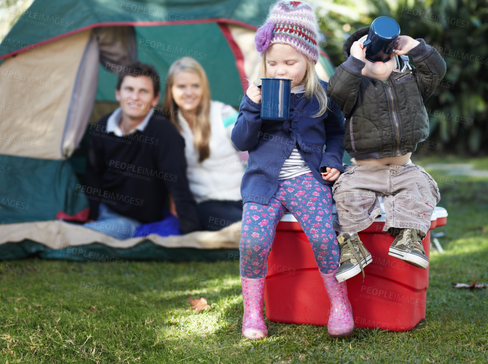 Buy stock photo Morning, coffee and family in nature for camping, relax and children bonding with a drink. Happy, parents and siblings or kids with tea or cacao while at a park for a holiday, vacation or camp