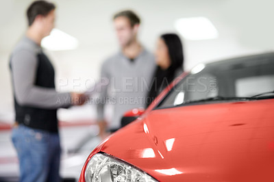 Buy stock photo Blurred view of a young couple buying a new car