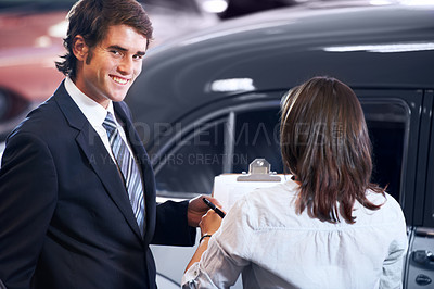 Buy stock photo Car dealership, woman and man with contract for deal, sale or sign for payment, smile or portrait. Guy, paperwork and happy for signature for legal agreement, loan and compliance for vintage vehicle