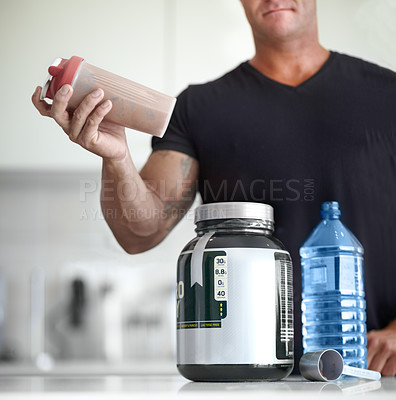 Buy stock photo Man, hands and protein shake for nutrition, muscle gain or body mass product and supplement on kitchen table. Hand of male bodybuilder preparing pre workout drink for exercise or healthy meal at home