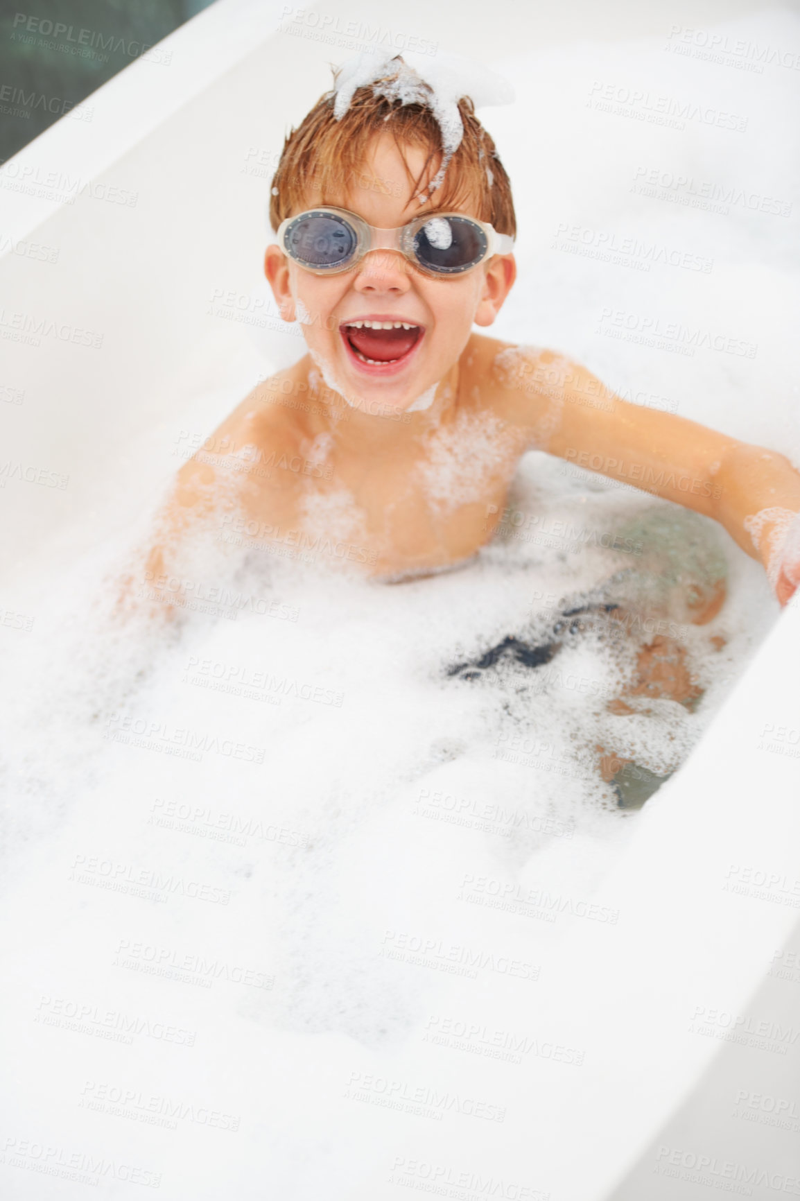 Buy stock photo Portrait of a cute young boy bathing with goggles