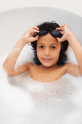 Buy stock photo Portrait, kids and bath with a boy in goggles while cleaning his skin in the home for natural hygiene. Face, children and a happy young kid in the bathroom to wash with soap in water from above