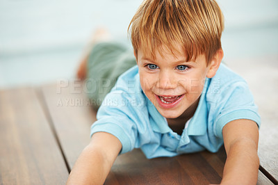 Buy stock photo Child, happy and playing game on floor in family home, security and learning with playing, growth and development. Boy, happiness and smile in living room for fun, care and excited in kindergarten