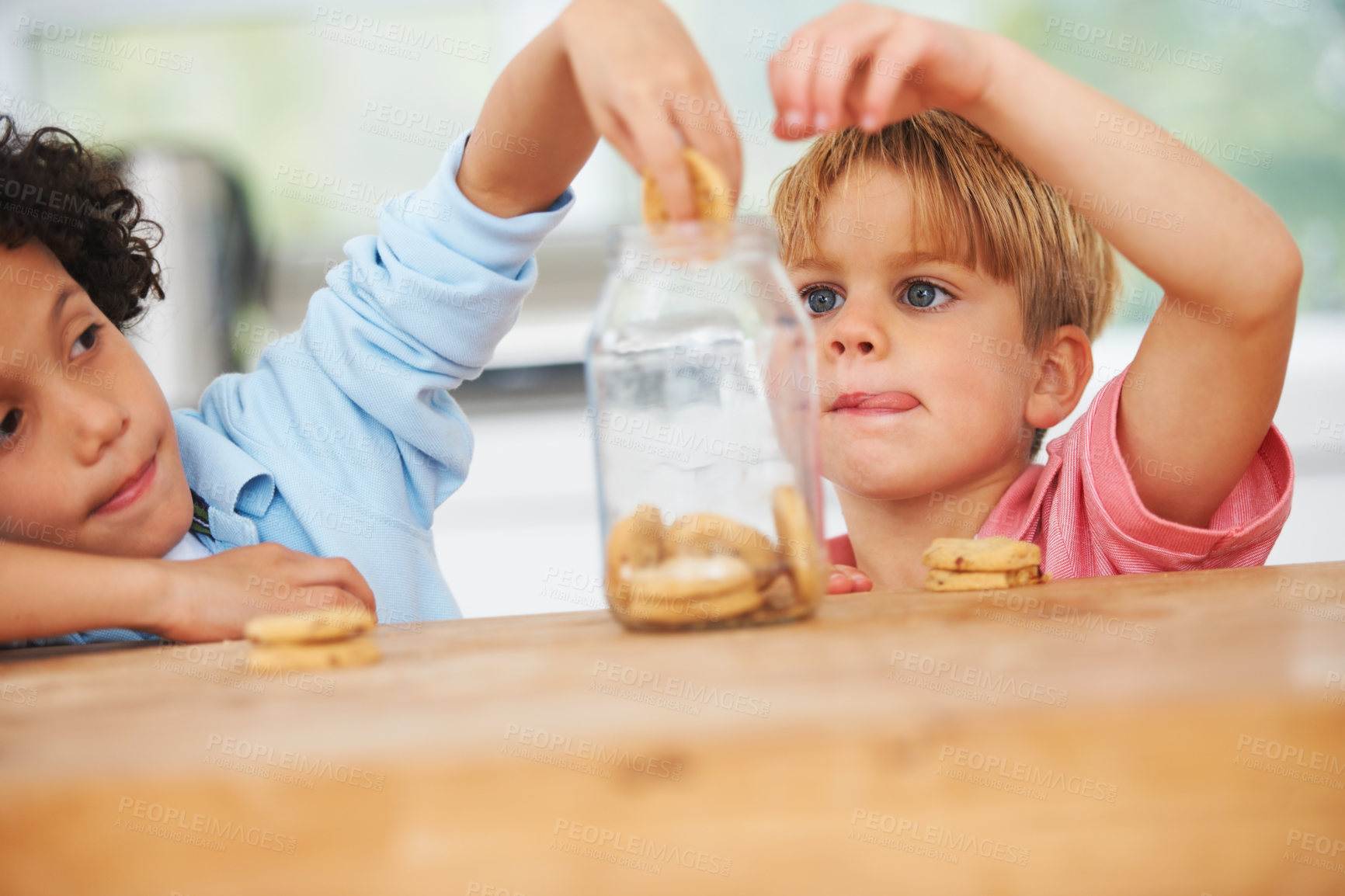 Buy stock photo A little boy grabbing some cookies